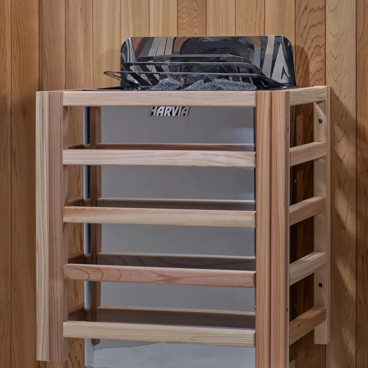 High-efficiency traditional electric sauna stove with volcanic rocks inside the Golden Designs Arlberg outdoor cabin.