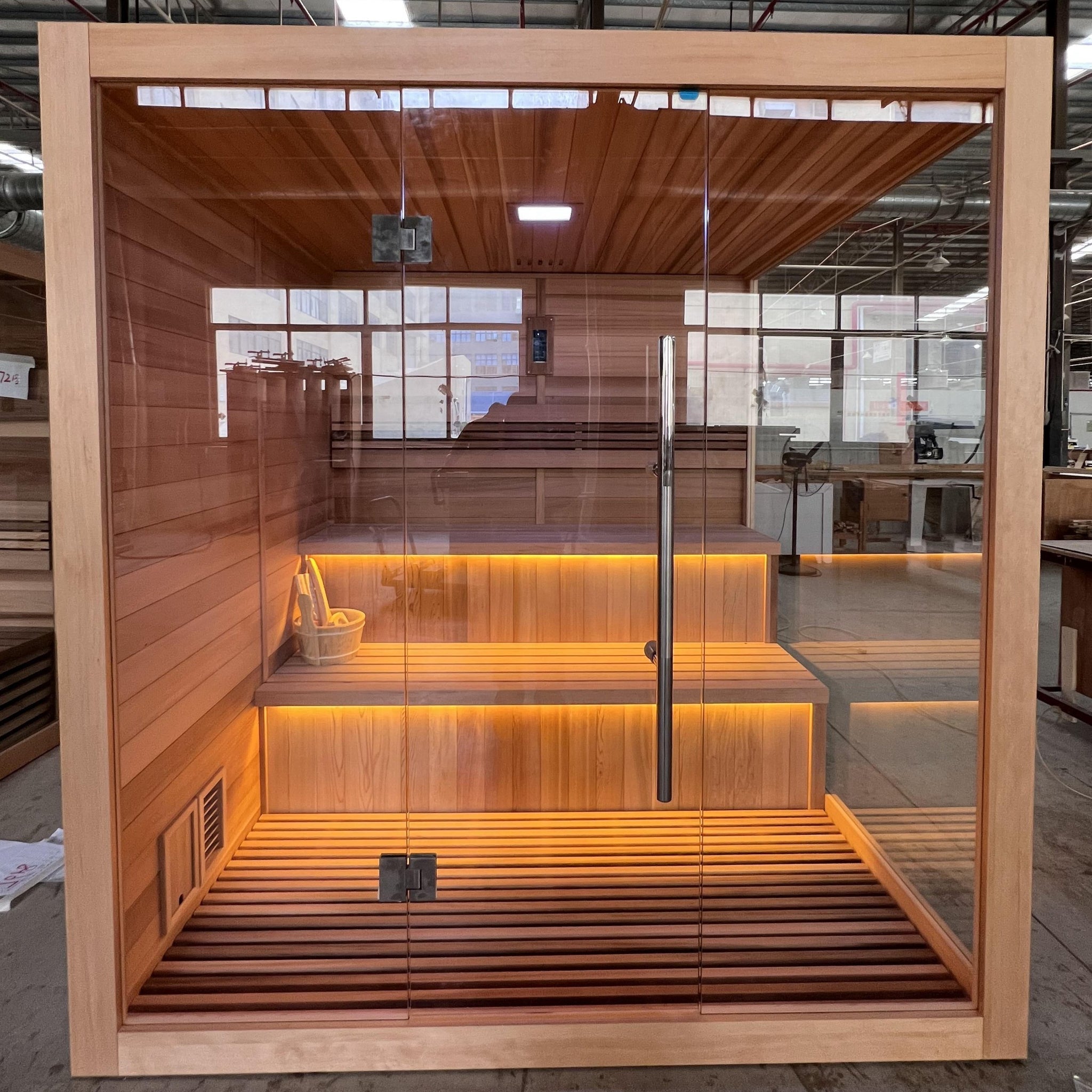 Spacious 6-person indoor traditional sauna cabin with Canadian red cedar interior and Hemlock exterior in Golden Designs Kuusamo Edition