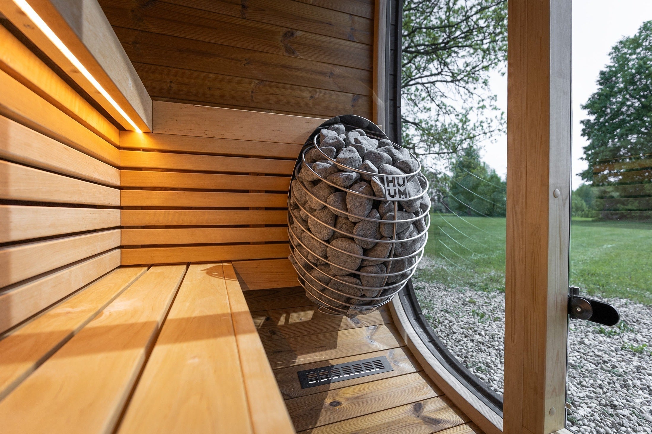 Leil Black Cube Classic luxury outdoor sauna with minimalist cube design, black Thermowood exterior, LED lighting, and spacious interior for family wellness