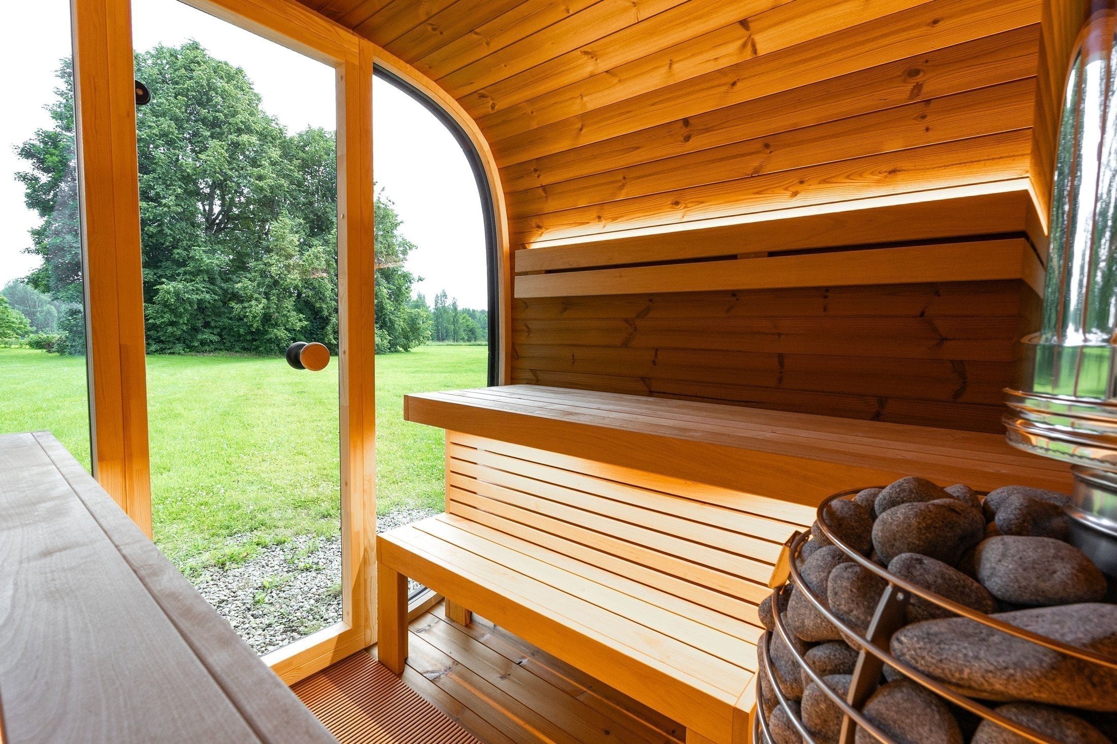Large Leil Black Cube Comfort ThermoWood Sauna offering comfortable seating for six and a stylish modern outdoor sauna experience