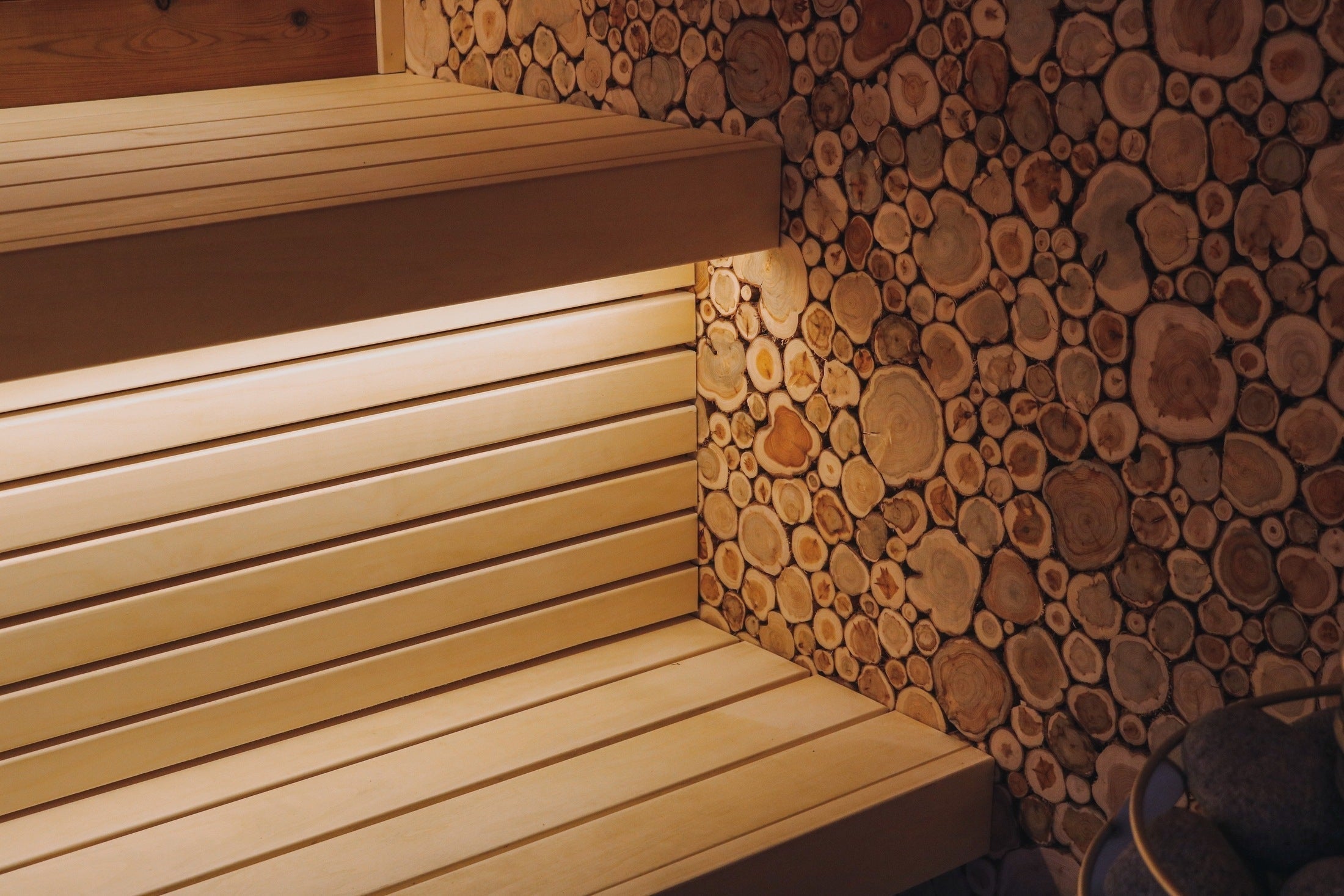 Spacious 6-8 person indoor seating outdoor sauna with ThermoWood benches and Nordic design
