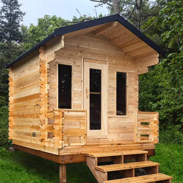 Dundalk CT Georgian 6 Person Outdoor Sauna with Porch CTC88PW handcrafted from Eastern White Cedar, featuring a traditional cabin design, covered front porch, tempered glass windows, metal roof, and spacious interior for outdoor backyard wellness