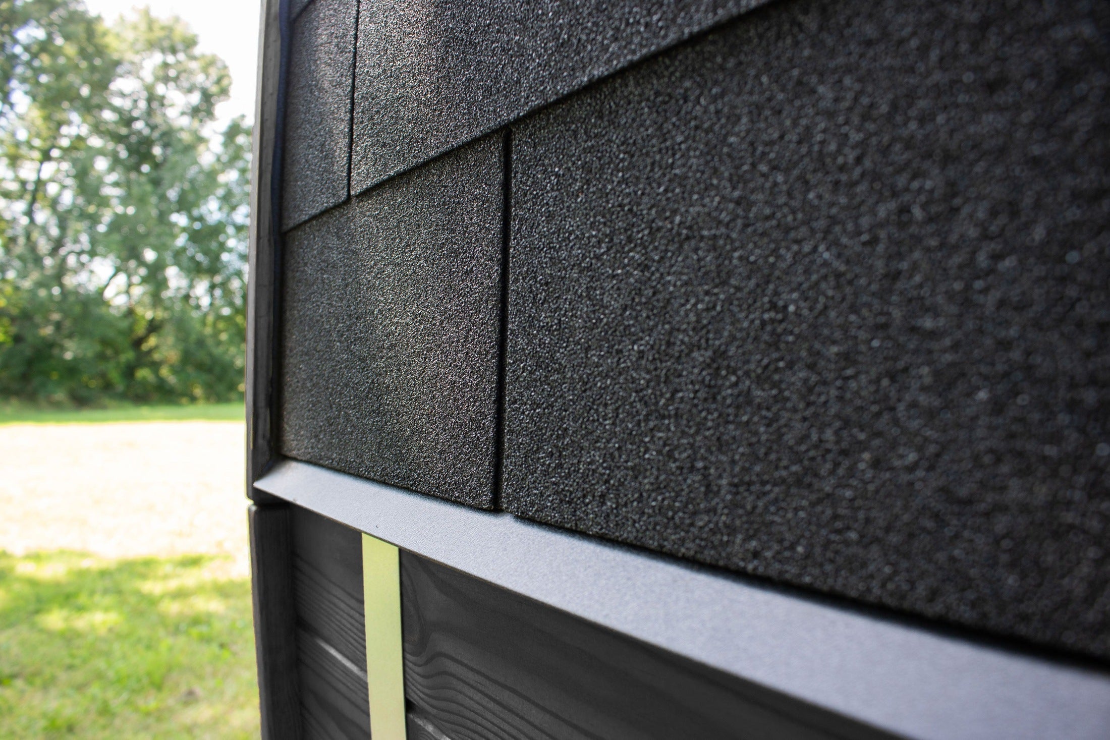 Premium outdoor sauna cabin by Leil, Black Cube Classic model with all-black Thermowood finish, smoked tempered glass, and spacious seating for 4 to 5 people