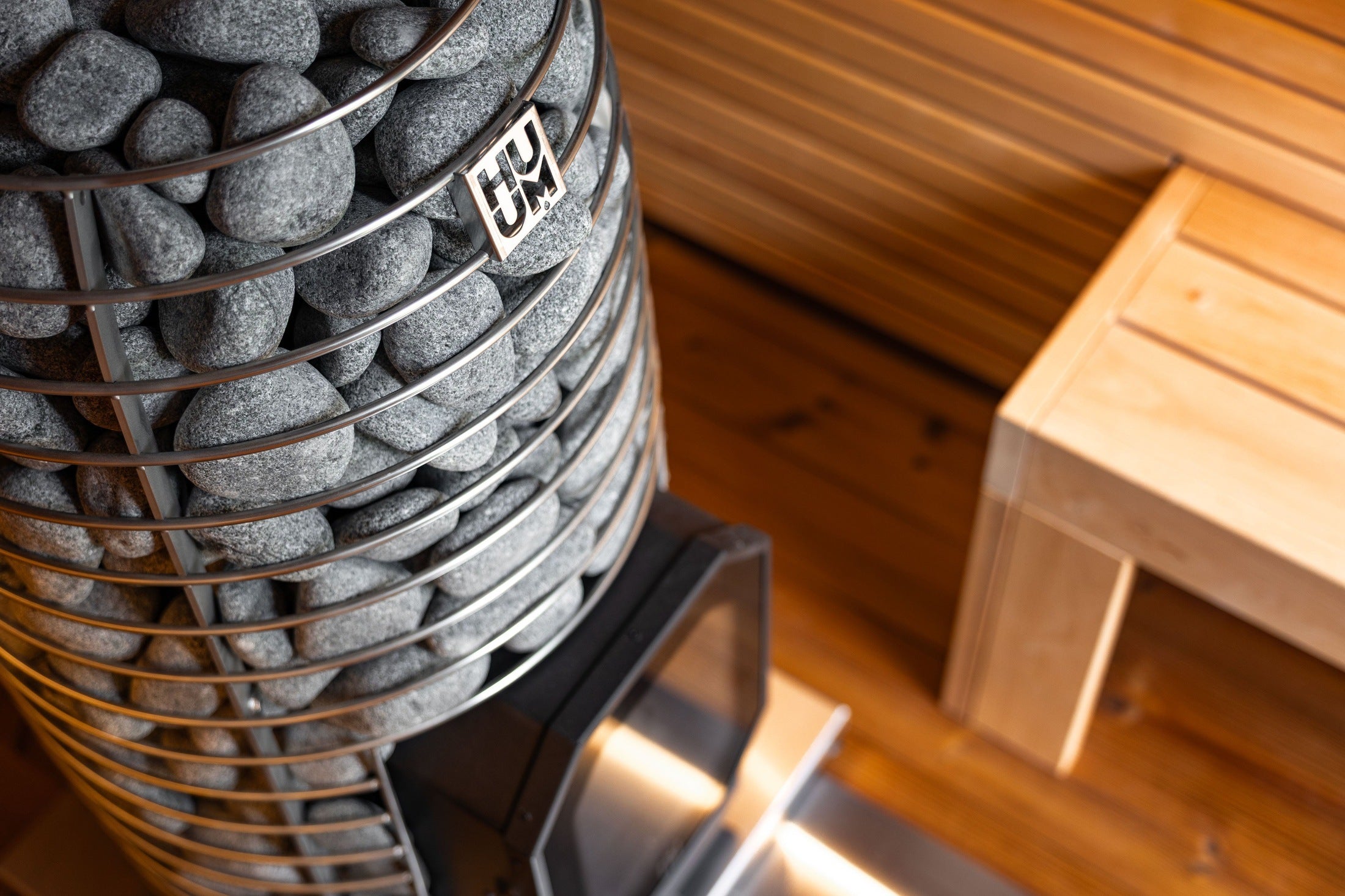 Leil BC-6 ThermoWood Outdoor Sauna with comfortable seating for six, sleek black exterior, and spacious social sauna layout