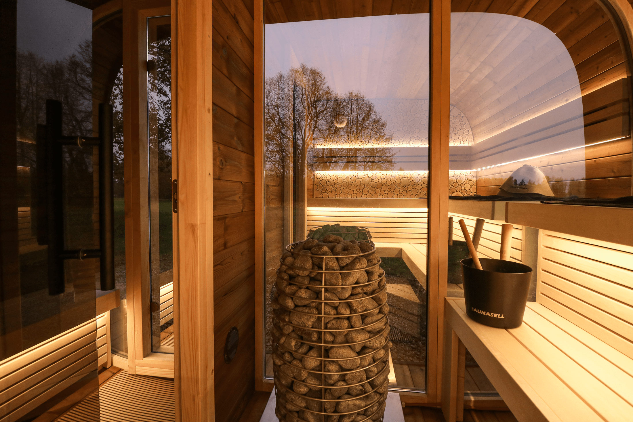 Modern 5–6 person outdoor sauna with changing room, Leil Round Cube Double ThermoWood backyard sauna cabin, Estonian handcrafted wellness spa
