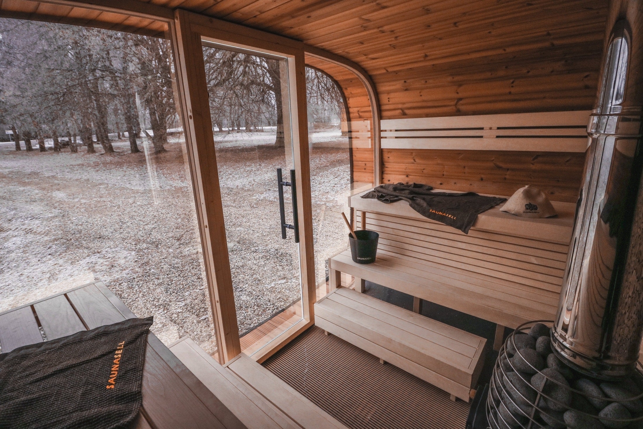 Modern 6-8 person outdoor sauna Leil Round Cube ThermoWood®, luxury Nordic backyard sauna with award-winning Estonian craftsmanship