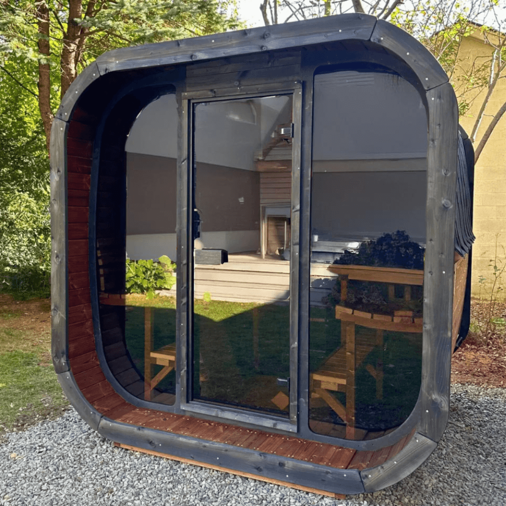 Modern luxury outdoor sauna SaunaLife CL7G Cube-Series featuring floor-to-ceiling glass front, spacious seating, and premium home wellness build