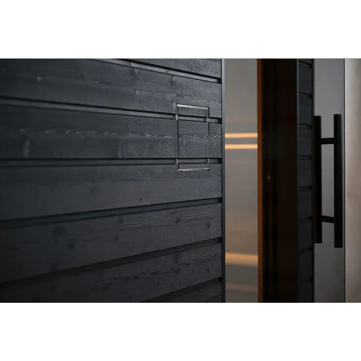 Pre-built SaunaLife Model G6 outdoor sauna cabin with elegant glass front, black painted spruce exterior, and high-end wellness spa design