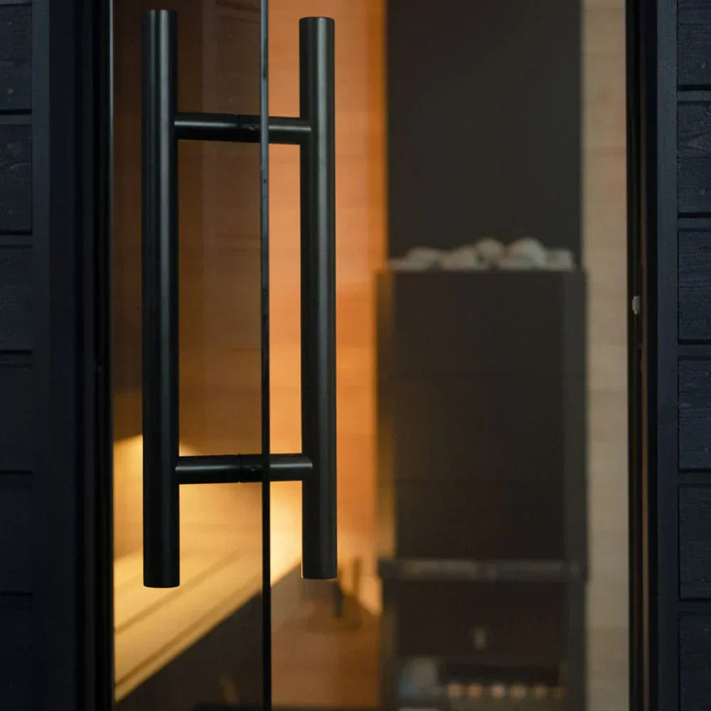 Premium SaunaLife G6 pre-built outdoor sauna cabin with clear glass door, black frame, and spacious wooden interior seating